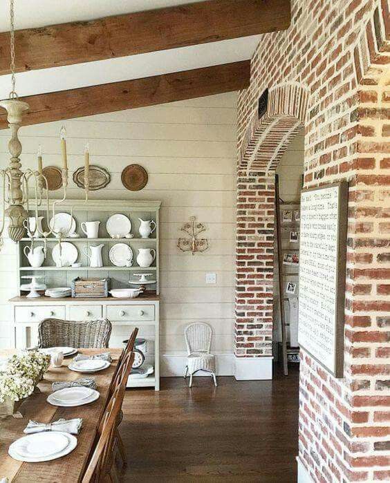 the dining room table is set with white plates