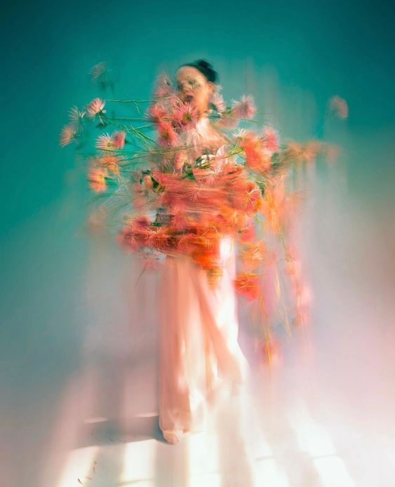 a woman with flowers in her hair and dress