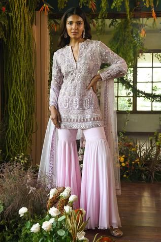 Pink short net kurta with mirror patra work, embellished bead-Swarovski and zardozi handwork. Comes with sharara pants and sheer dupatta.
Components:3
Embroidered
Neckline:Round
Sleeve Length:Long
Fabric:Net, Georgette
Color:Pink
Split neck
Side slits - Aza Fashions Pink Sharara, Lehenga Pink, Aashni And Co, Georgette Sharara, Brocade Lehenga, Desi Clothing, Embroidered Sharara, Sharara Pants, Indian Luxury