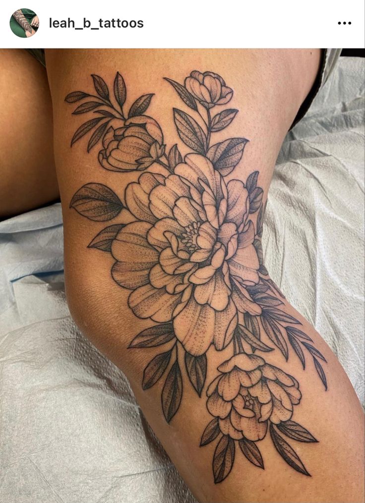 a woman's thigh with flowers on it