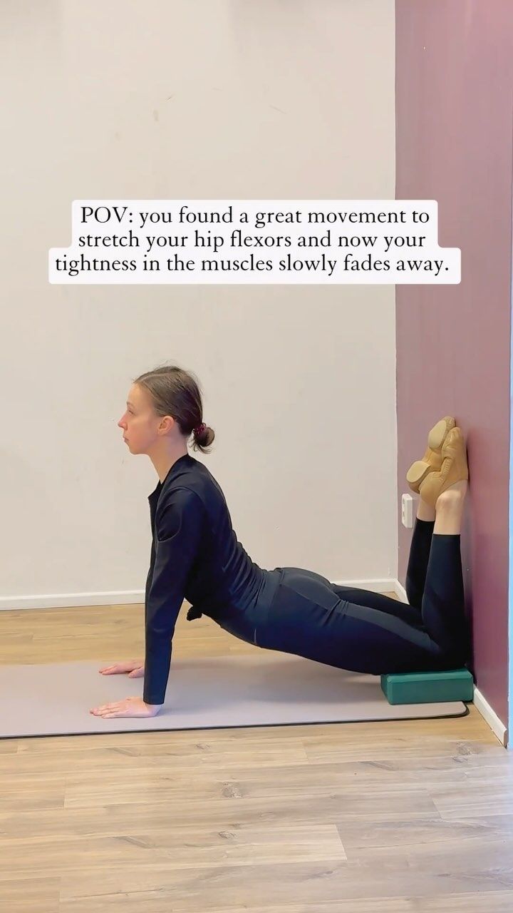 a woman doing a yoga pose with her feet on the ground and one leg up in the air