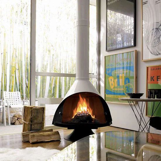 a living room filled with furniture and a fire place in the middle of it's fireplace