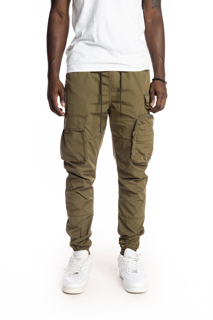 Multi Pocket Cargo Windbreaker Pant - Olive – SMOKERISENY.COM Money Making Machine, Nylon Pants, Cargo Shorts, Elastic Band, Waist Size, Cargo Pants, Parachute Pants, Woven Fabric, Zipper Pocket