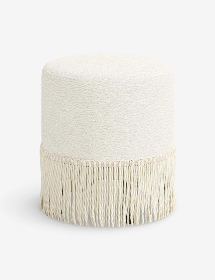 a white stool with fringes on it