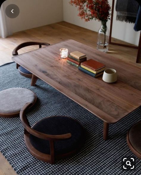 a wooden table sitting on top of a blue rug