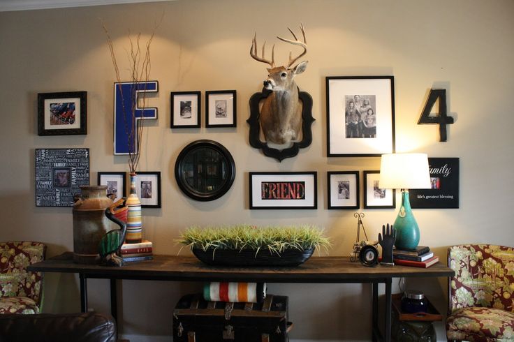 a living room filled with furniture and pictures on the wall