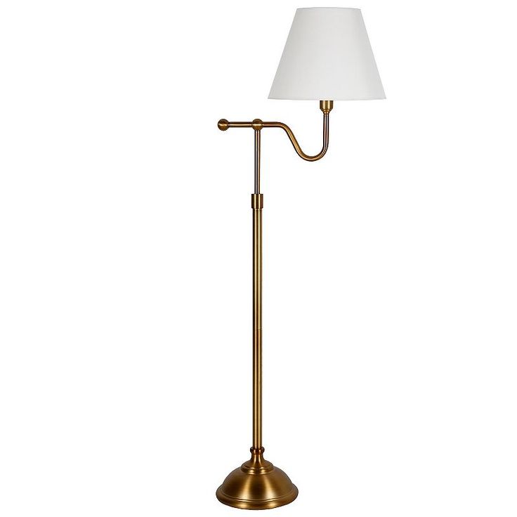 a brass floor lamp with a white shade on the top and bottom part of it