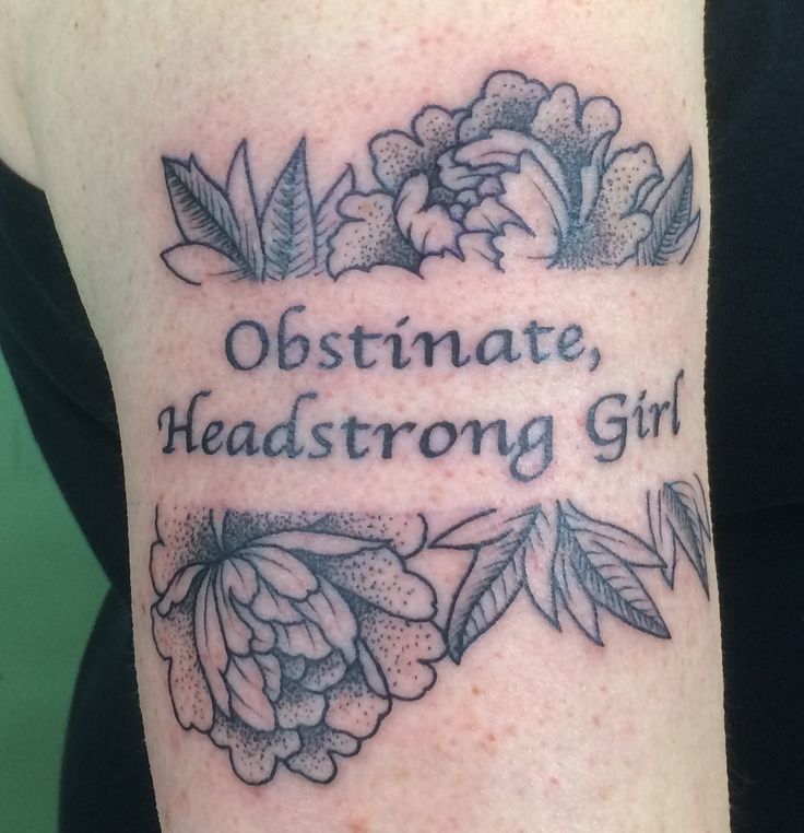 a woman with a tattoo on her arm that says, obstmate, headstrong girl