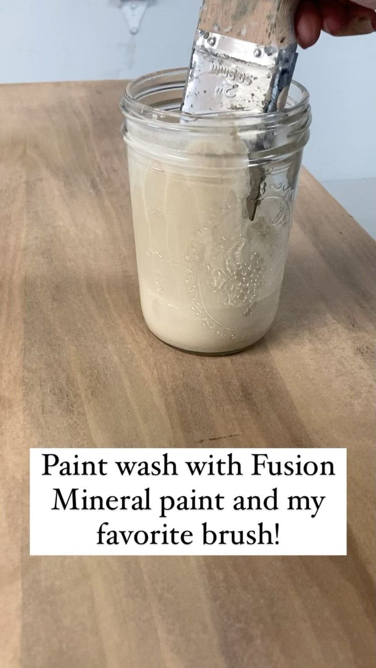 someone is painting the inside of a mason jar with white paint and my favorite brush