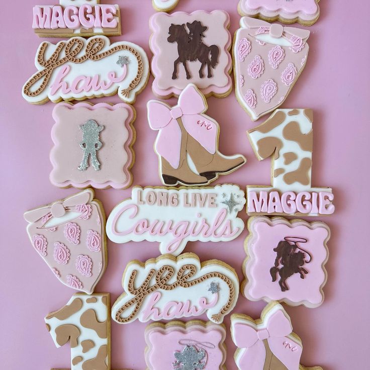 decorated cookies are arranged in the shape of cowgirls and cowboy boots on a pink background