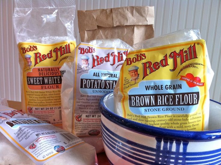 some bread and flour are sitting in a bowl on the table next to each other