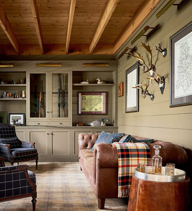 a living room filled with furniture and deer heads on the wall