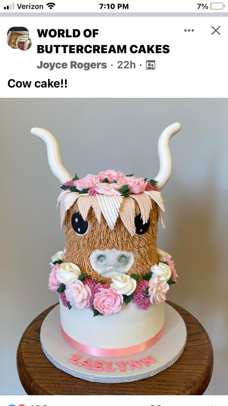 the cake is decorated with flowers and a cow's head