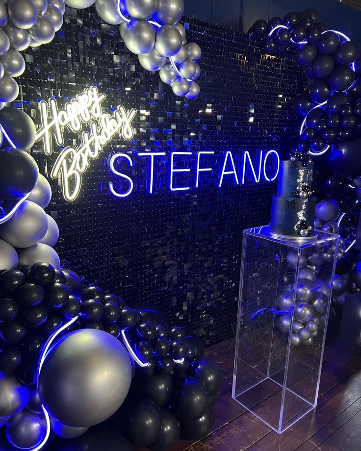 balloons and streamers are on display in front of a sign that reads happy birthday steffano