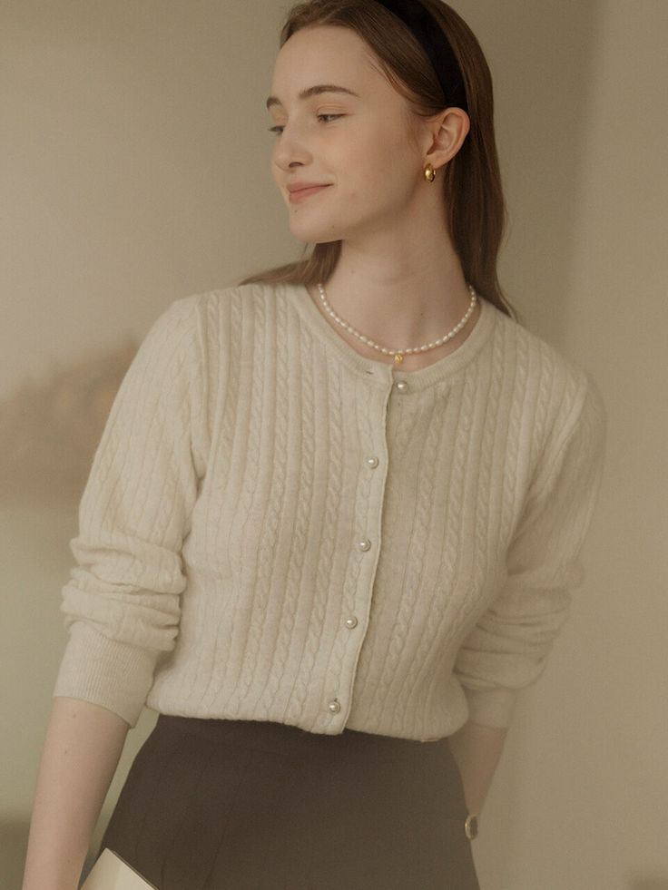 Editor's NotesThis is a luxurious cardigan with a combination of classic weaving and delicate pearl buttons. It harmonizes with various items with a soft and delicate color sense. Containing cashmere, you can wear it comfortably with a soft and not thick texture.- Creates a neat and lovely feeling with a moderately deep round neck- Neat silhouette with dense weaving and finishing- Gold color TILLIDIE logo decorationMeasurements(in.)ONE SIZE (XS-M)- Length: 20.87 in.- Shoulder: 13.78 in.- Chest: 19.69 in.- Sleeve: 24.02 in.- Sleeve Hem: 3.54 in.*Model Size: Height 5'68, Bust 33.5, Waist 23.5, Hip 35*Since there are individual differences in size, please check the size chart before ordering.*The actual size of the product is based on the cross-section of the product after spreading it out on Elegant Cream Cardigan With Buttons, Elegant Beige Sweater With Buttons, Elegant Beige Winter Cardigan, Elegant Cream Winter Cardigan, Elegant Cashmere Cardigan With Button Closure, Elegant Cream Sweater With Button Closure, Elegant Cream Sweater With Buttons, Elegant Spring Sweater With Button Closure, Elegant Cashmere Sweater For Daywear