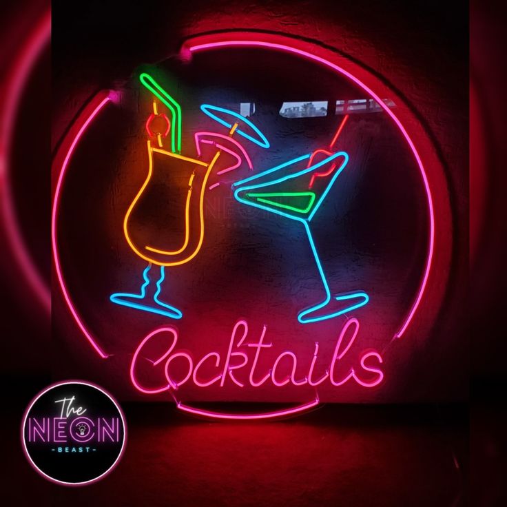 a neon sign that says cocktails with a martini in the glass and a lime