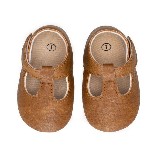 Not only do they have an elastic stretch, but they are so easy to get on and off! All of our moccasins are designed to stay on your child's feet, and the Moxford® is no exception! Each shoe is lined with cotton to keep the foot dry and warm. Sizes 4 and up have hard soles for any new walking babe in your home! To ensure ordering a proper size, please measure your child’s foot prior to ordering. We recommend adding 1/2″ to your child’s foot measurement for growing room. SIZING: sz 1 0 - 4 months Brown Non-slip Slip-ons, Brown Moccasins For Playtime With Round Toe, Brown Non-slip Closed Toe Slip-ons, Spring Brown Booties With Soft Sole, Comfortable Non-slip Brown Slip-ons, Casual Brown Non-slip Booties, Brown Slip-on Booties With Soft Sole, Brown Non-slip Slip-on Booties, Brown Non-slip Round Toe Moccasins