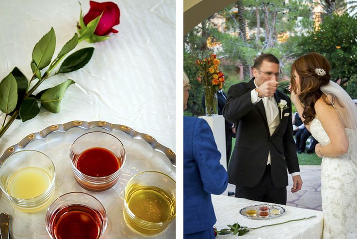 a bride and groom standing next to each other at a table with glasses of wine