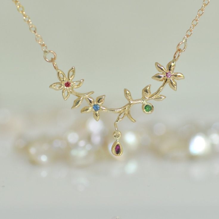 "This 14K gold flower necklace is a perfect love gift. This gold necklace and gemstone is a solid gold chain and pendant. That unique pendant is 3 small flowers and leaf and a tiny gold teardrop. Every small flower has a little gemstone in the center. The tiny teardrop has a marquise, Ruby. You can wear this unique gold necklace every day with every look. You can ask for different gemstones in the center of the flowers and in the little drop. Please let me know the length of the chain that you w Gold Gemstone Necklaces With Flower Design, Elegant Gold Birthstone Necklace With Flower Charm, Gold Flower Shaped Gemstone Necklace, Yellow Gold Gemstone Necklace In Flower Shape, Yellow Gold Flower Necklace With Gemstone, Yellow Gold Flower Shaped Gemstone Necklace, Yellow Gold Flower-shaped Gemstone Necklace, Flower Shaped Necklace With 17 Jewels For Gift, Yellow Gold Birthstone Necklace With Flower Pendant