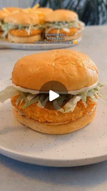 a chicken sandwich on a plate with lettuce