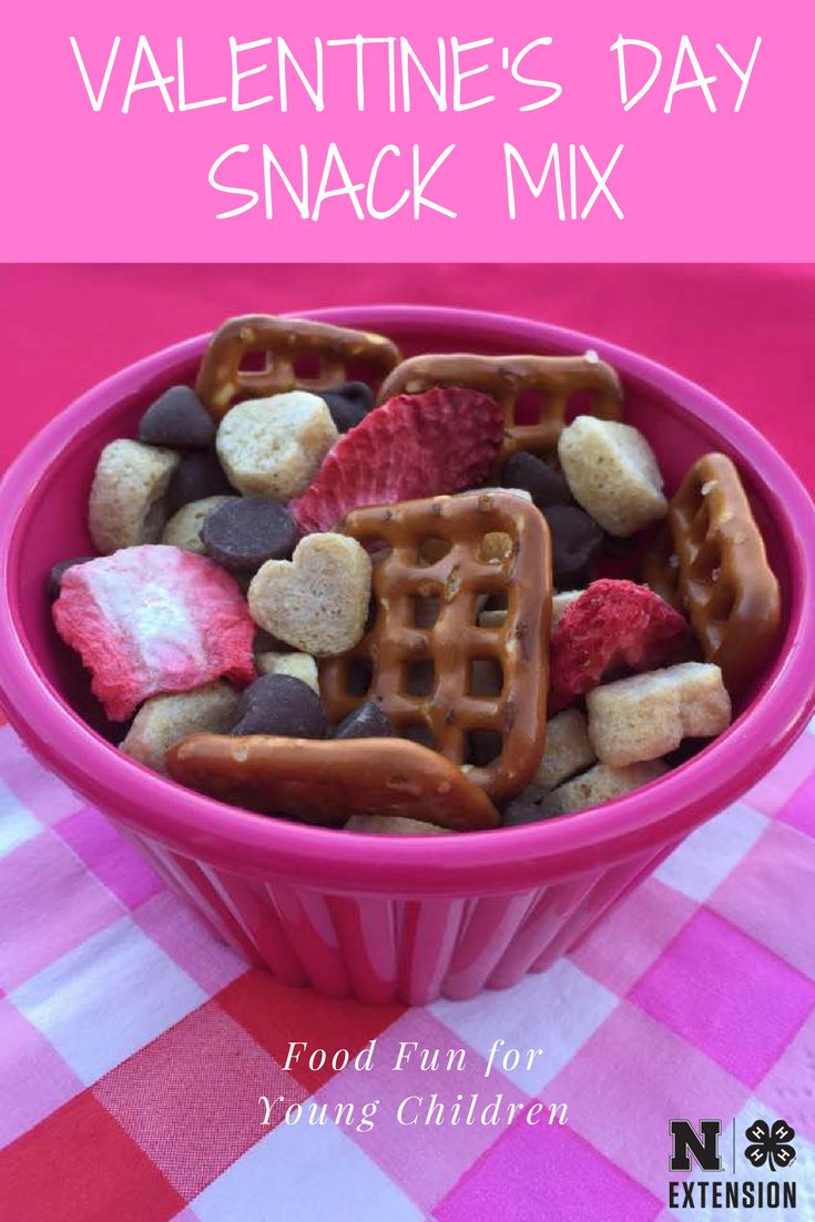 valentine's day snack mix in a pink bowl on a checkered tablecloth