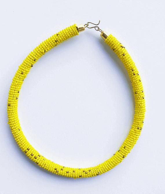 Bright yellow elegant beaded choker necklace with specs of golden beads inspired by Oshun goddess. Approximately 18” long.Instagram: https://www.instagram.com/exoticbodybeads/Twitter: https://twitter.com/exoticbodybeadsThank you for shopping with us. Yellow Beaded Choker For Festivals, Yellow Choker Necklace For Festivals, Yellow Round Beads Choker For Festivals, Yellow Tiny Beads Jewelry For Festival, Yellow Beaded Choker Necklace For Festivals, Yellow Choker With Round Beads For Festivals, Yellow Tiny Beads Festival Jewelry, Yellow Festival Choker With Round Beads, Adjustable Yellow Choker With Tiny Beads