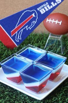 an american football and some ice cubes on a plate with the ball in the background