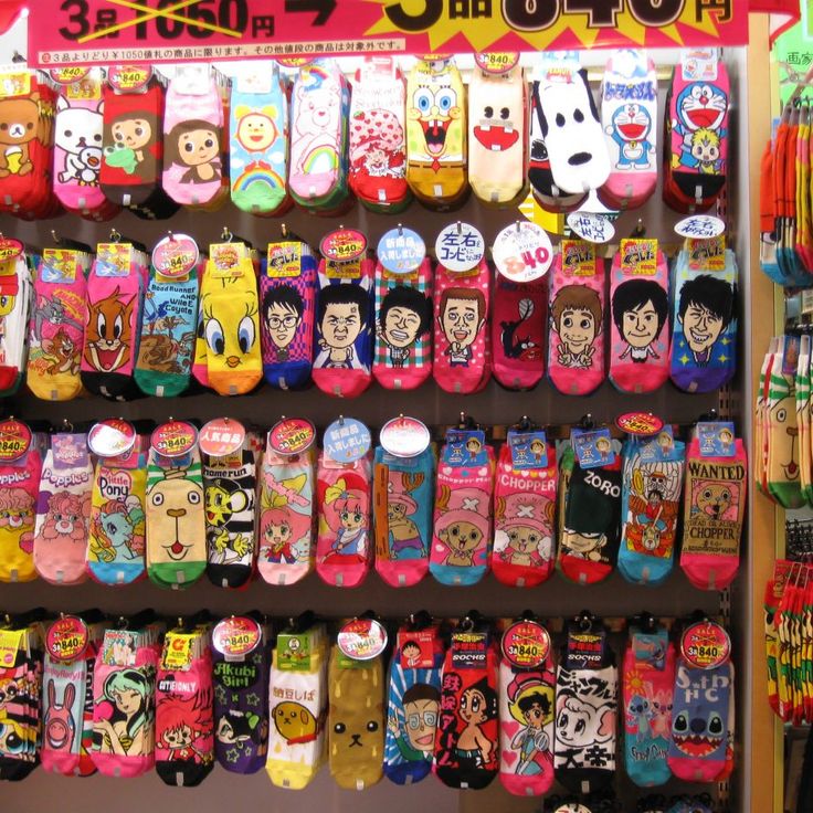 there are many colorful socks on display in the store, and one is for sale