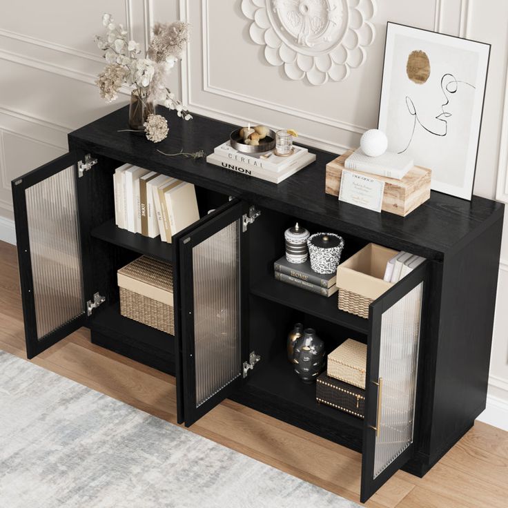 a black book shelf with books and magazines on it in front of a white wall