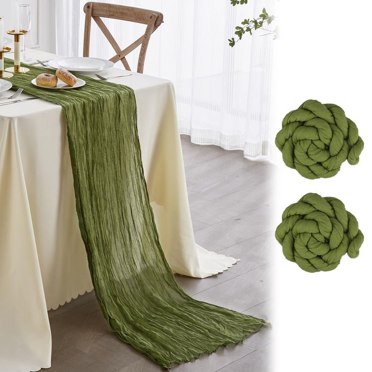 the table is set with green napkins and place settings for two people to eat