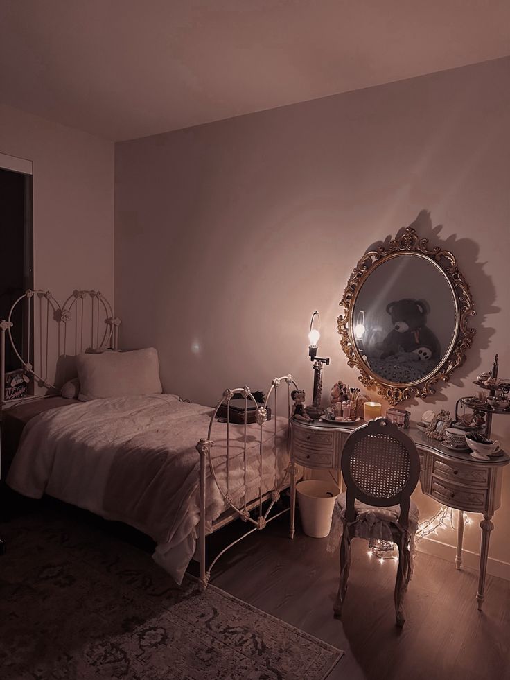 a bedroom with a bed, dresser and mirror on the wall next to a chair