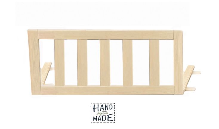 a wooden baby crib with the word hand made on it's bottom corner