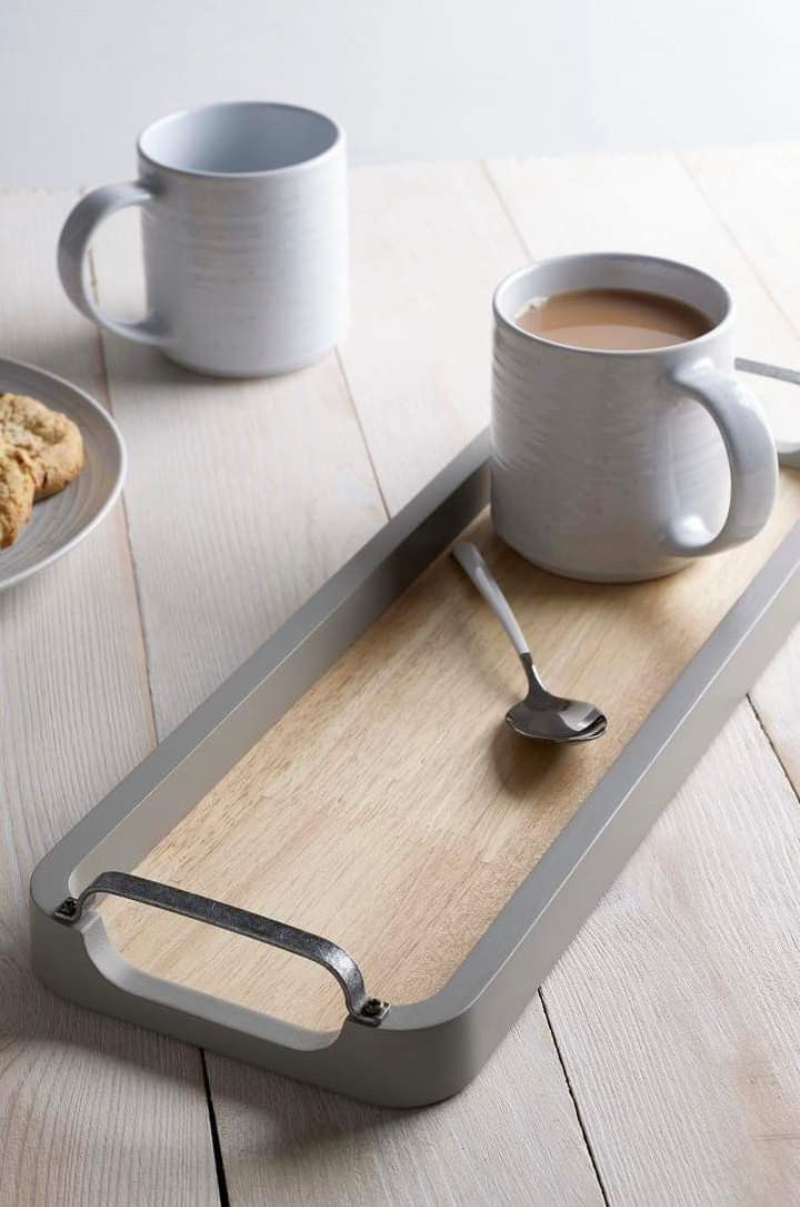 there is a tray with a cup of coffee on it and two cookies next to it