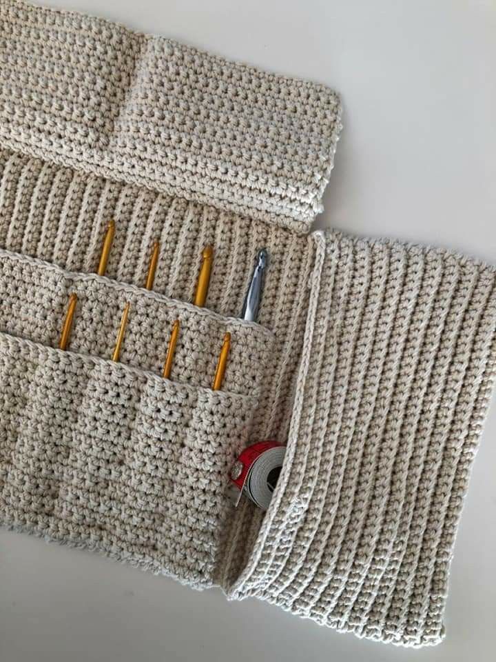 two crocheted pouches with pencils and scissors in them