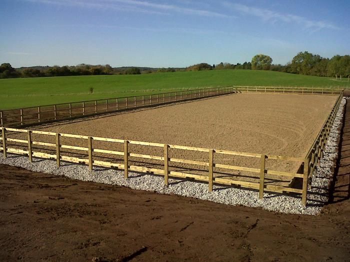 an empty horse paddock in the middle of a field