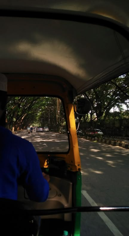 a man driving a small truck down a street