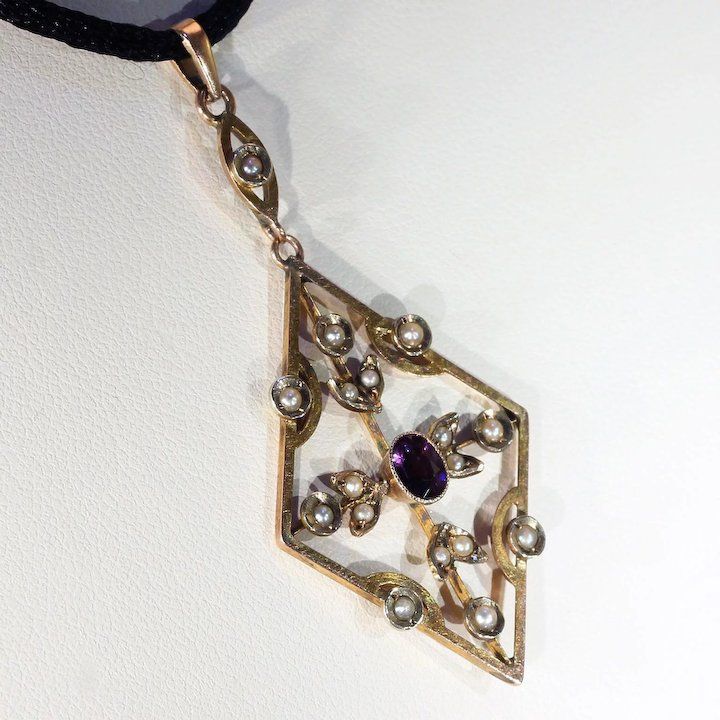 During the Edwardian era, feminine motifs with delicate yet understated designs were considered en vogue. Natural pearls, amethysts, peridots, aquamarines, and other semi-precious stones were worn by affluent women to complement the trend of donning white silk and lace. This jewelry movement differed from the larger and dark colored jewels of the later Victorian era, it was a fresh and welcome change that breathed life back into fashion. This pendant would have been incredibly stylish for its ti Elegant Yellow Gold Amethyst Necklace, Purple Diamond Jewelry With Rose Cut, Elegant Marquise Amethyst Jewelry, Purple Diamond Jewelry With Rose Cut Diamonds, Elegant Amethyst Pendant Jewelry, Elegant Yellow Gold Jeweled Necklace, Rose Cut Amethyst Jewelry For Wedding, Purple Amethyst Jewelry With Rose Cut Diamonds, Elegant Amethyst Jewelry