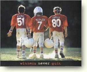 three young football players walking on the field