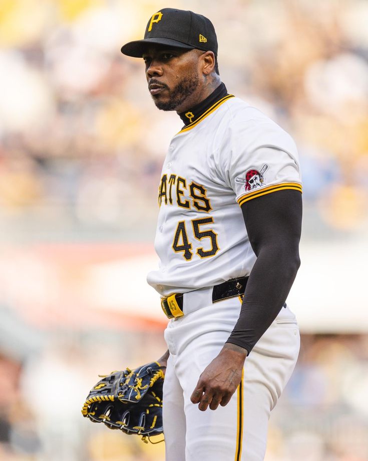 a baseball player standing on top of a field wearing a catcher's mitt