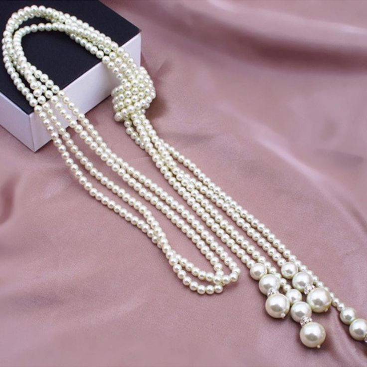 Gorgeous pearl sweater necklace that is sure to please. This necklace can be worn with virtually any outfit (even turtleneck sweaters) for a bold but classy touch. Includes free earrings. Total length is 49". Long Tassel Necklace, Long Pearl Necklaces, Retro Jewelry, Faux Pearl Necklace, Freshwater Pearl Necklaces, Pearl Chain, Stainless Steel Necklace, Accessories Necklace, Gatsby