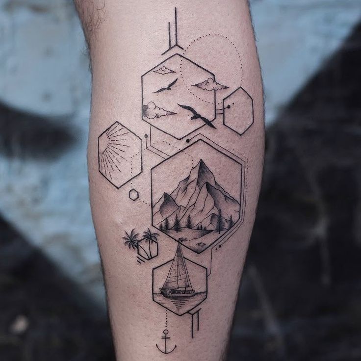 a man's leg with a mountain and sailboat tattoo on the side of his calf