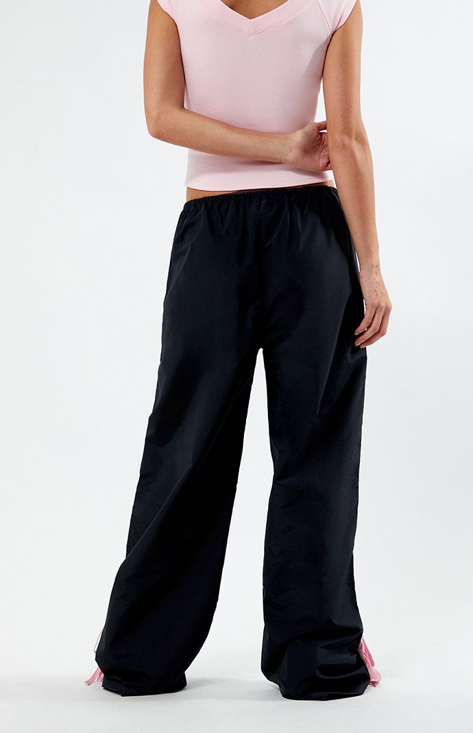 Step into athleisure vibes with the PacSun Black Wide Leg Track Pants. These trendy track pants combine comfort and style with a wide-leg silhouette, stripes down the leg, and ties at the ankles, offering a versatile and laid-back addition to your wardrobe, perfect for casual outings or cozy days at home.


	11.5" rise
	31.5" inseam
	23" leg opening
	High-rise
	Elastic waistband
	Stripes down the legs
	Tie detail at the ankle
	Side hand pockets
	Wide leg opening
	Relaxed fit
	Room Wide Leg Track Pants, Track Pants Women, Indie Brands, Pant Shirt, Short Rompers, Skirted Swimwear, Basic Tees, Hoodie Dress, Pacsun