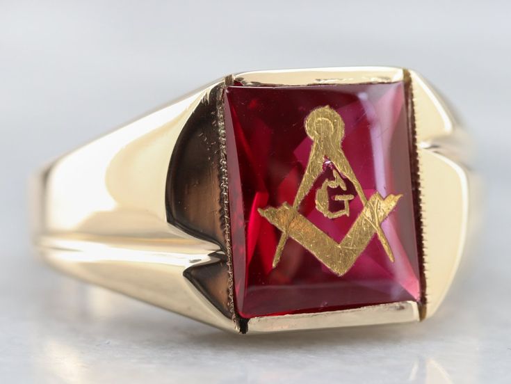 This vintage red ruby glass Masonic ring features polished, structurally simple shoulders, and a simple rectangular shape. The center is a classic red ruby glass cabochon, inlaid with the gold Masonic symbol, with a nice flat profile. Metal: 10K Yellow Gold Gem: Ruby Glass Gem Measurements: 12.0 x 10.1 mm, Rectangle Ring Size: 12.50 Marks: "10K" Stamped on the inside band Red Rectangular Ring With Polished Finish, Red Rectangular Rings With Polished Finish, Rectangular Red Rings With Polished Finish, Classic Ruby Ring With Polished Rectangular Finish, Classic Ruby Ring With Rectangular Polished Finish, Classic Rectangular Ruby Ring With Polished Finish, Luxury Rectangular Ruby Ring, Classic Red Signet Ring For Formal Occasions, Gold Ruby Signet Ring With Polished Finish