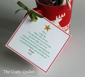 a red cup filled with candy canes next to a christmas card