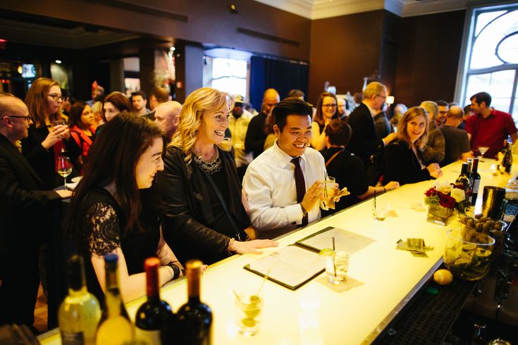 a group of people sitting at a bar