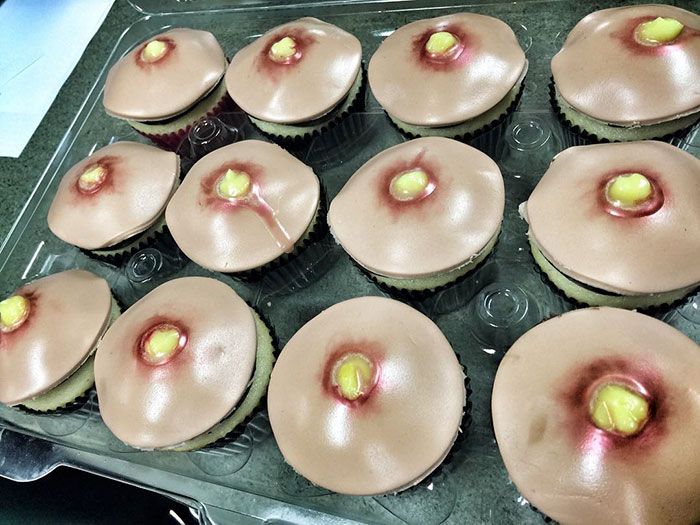 there are many cupcakes with pink icing and a tennis ball on them