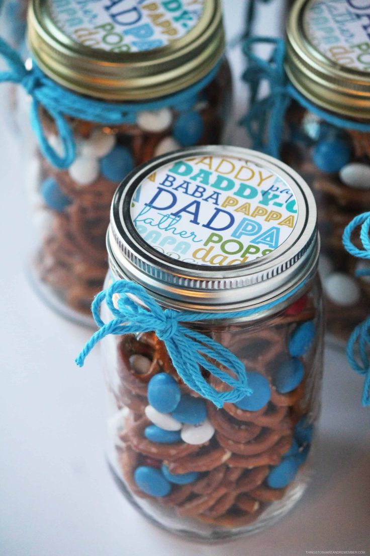 mason jar filled with baby's first birthday party favors for the boys and girls