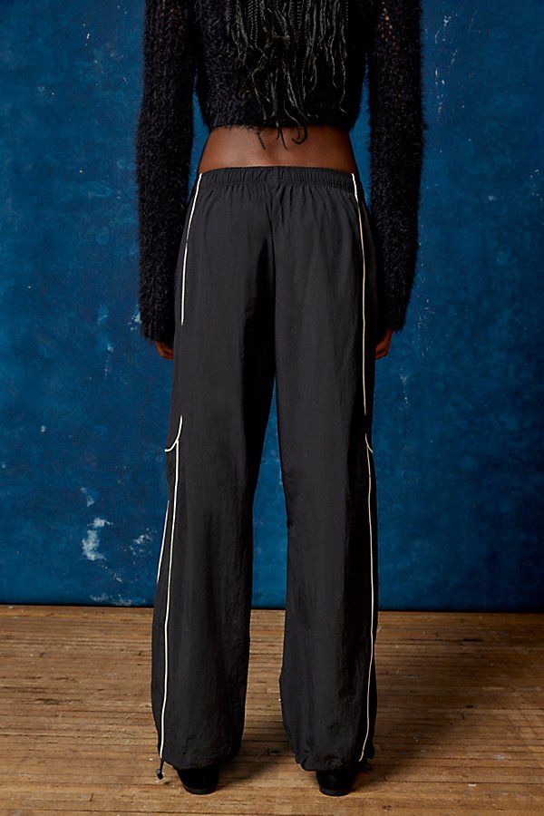 Effortless track pants from BDG. Our BDG Jess nylon track pants have an easy fit with a low rise and a relaxed straight leg. Essential track pants styling with contrasting piping at the sides. Find these staple track pants only at Urban Outfitters. Features BDG Jess nylon track pants Wide leg track pant Mid rise elasticated waistband Side pockets Piping down the legs Relaxed, straight-leg fit Full length Pull-on style UO exclusive Content + Care 100% Nylon Machine wash Imported Size + Fit Model Sporty Wide Leg Nylon Sweatpants, Nylon Straight Leg Athleisure Pants, Sporty Wide-leg Sweatpants, Athleisure Nylon Straight Leg Bottoms, Nylon Straight Leg Athleisure Bottoms, Nylon Straight Leg Bottoms For Athleisure, Sporty Full-length Nylon Parachute Pants, Sporty Full Length Nylon Parachute Pants, Sporty Parachute Pants With Straight Leg And Elastic Waistband