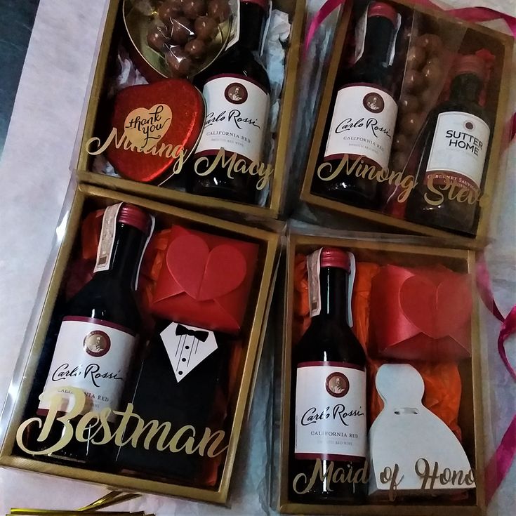 four bottles of wine and some chocolates in a box