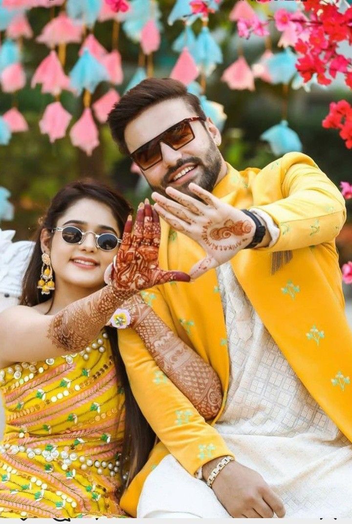 a man and woman posing for a photo with their hands on each other's chest